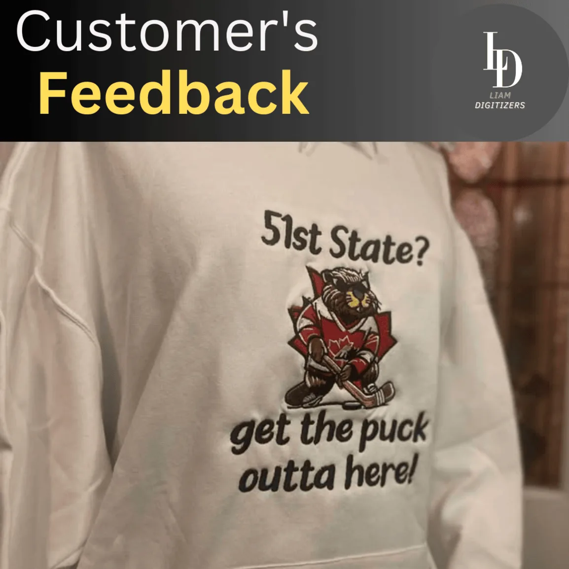 Embroidered beaver in hockey gear on a cream hoodie with the text 51st State? Get the puck outta here